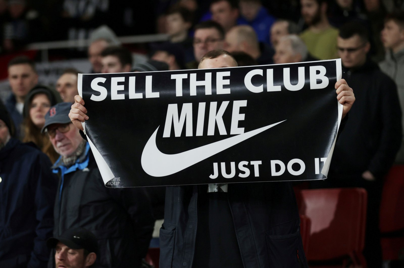 A fan displays a banner in reference to Newcastle United owner Mike Ashley during a match, in London, Britain, Feb. 16, 2020.  (Reuters Photo)