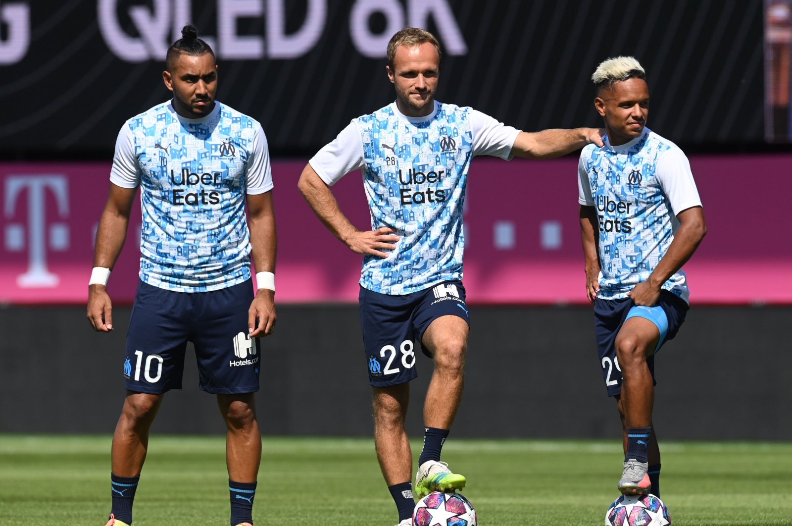 Marseille's Dimitri Payet (L), Valere Germain (C) and Florian Chabrolle (R) stand on the pitch before a match, in Munich, Germany, July 31, 2020. (AFP Photo)