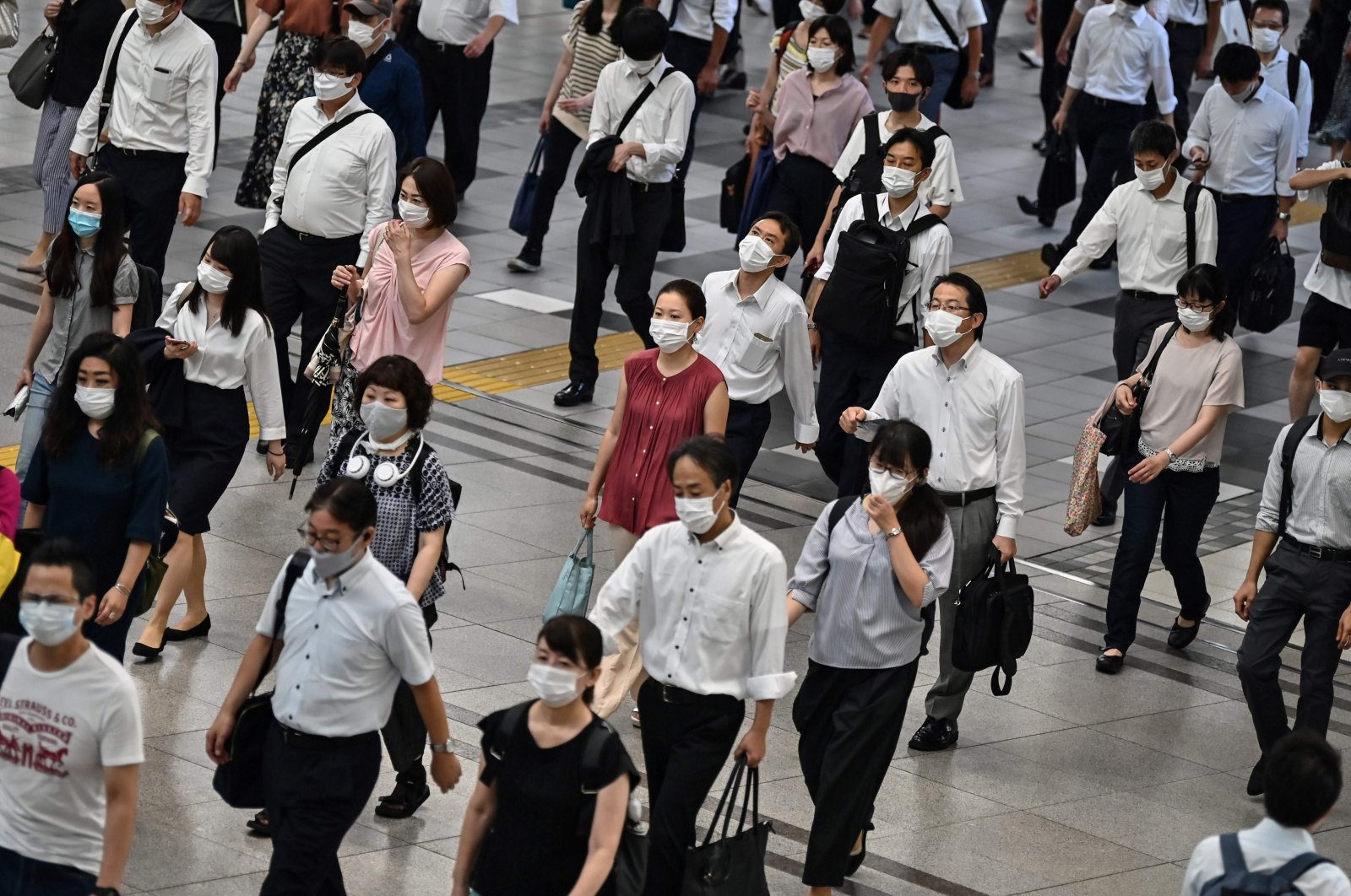 People commute on an early morning in Tokyo, Japan, Aug. 17, 2020. (AFP Photo)