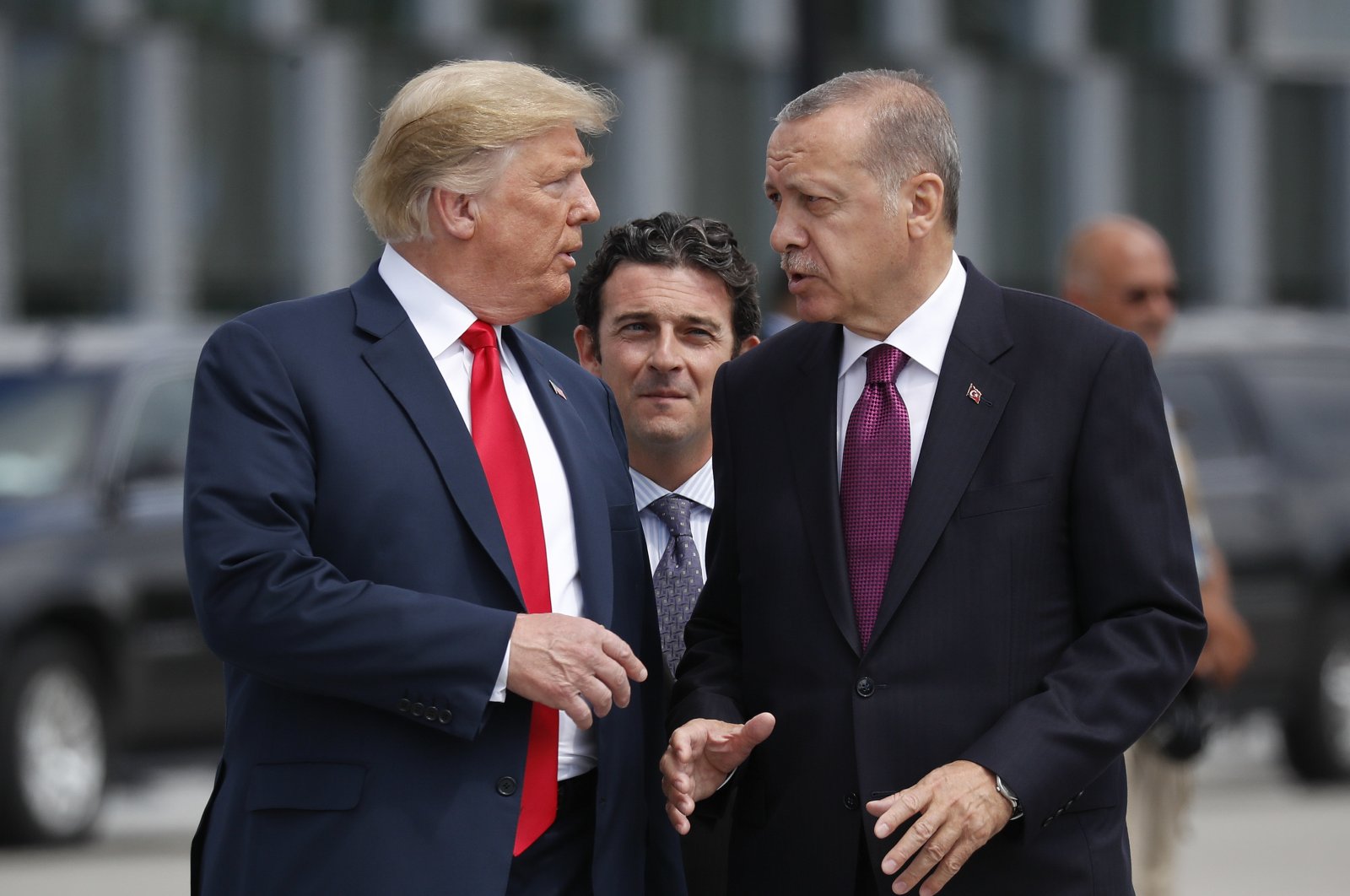 U.S. President Donald Trump (L) talks with President Recep Tayyip Erdoğan as they arrive together for a family photo at a summit of heads of state and government at NATO headquarters in Brussels, July 11, 2018. (AP Photo)