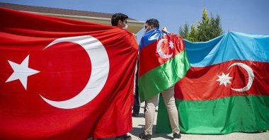 Two young men are seen side by side with the flags of Turkey and Azerbaijan as a symbol of the solidarity between the two countries, in this photo provided on Aug. 17, 2020. (AA PHOTO)