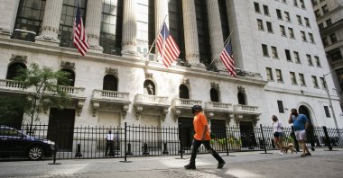 People walk by the New York Stock Exchange, New York City, U.S., July 21, 2020.