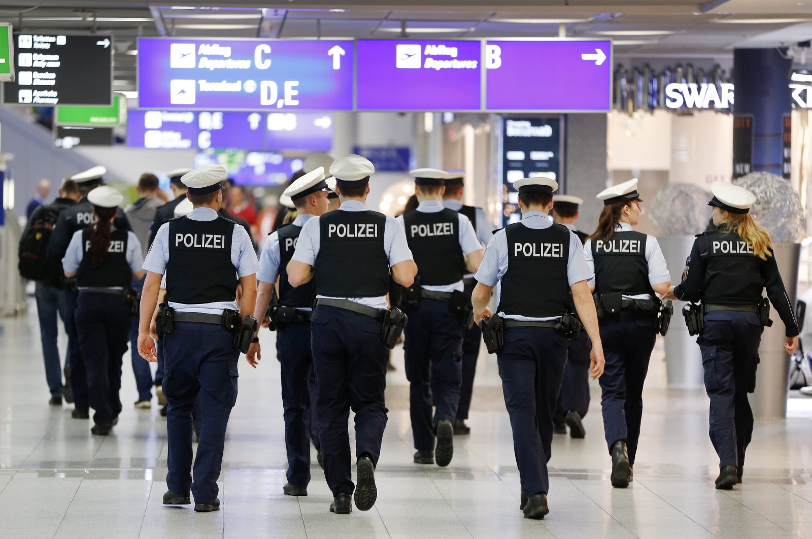 German police officers walk in an airport terminal, Frankfurt, March 23, 2016. (AP Photo)