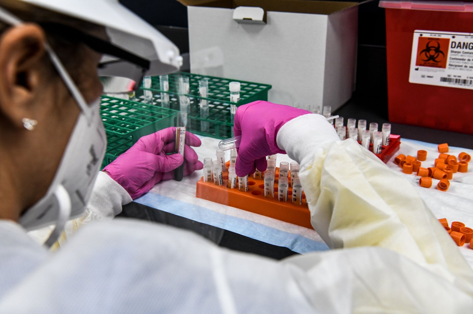 A lab technician sorts blood samples inside a lab for a COVID-19 vaccine study at the Research Centers of America (RCA) in Hollywood, Florida, U.S., Aug. 13, 2020. (AFP Photo)