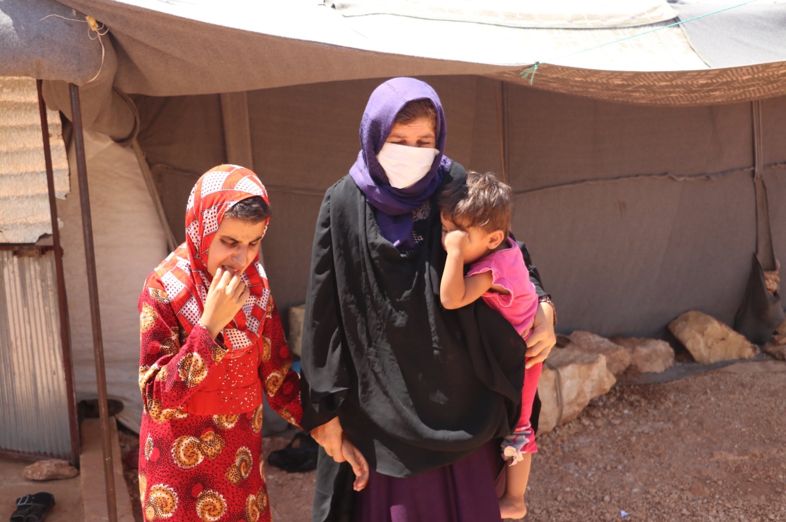 Displaced Syrian mother Gulsum al-Musa with two of her blind children, Idlib, Aug.18, 2020. (AA) 