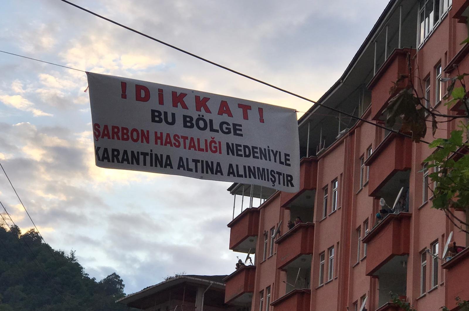 A sign reading "Attention! This place is quarantined due to anthrax" hangs between buildings in the Sürmene district in Trabzon, northern Turkey, Aug. 18, 2020. (DHA Photo)