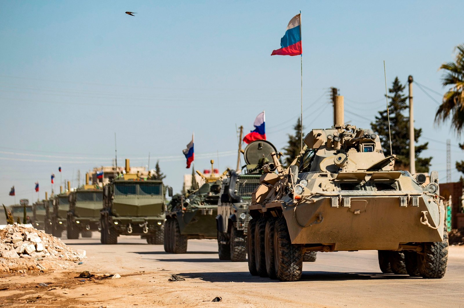 Russian military vehicles driving in a convoy from the town of Tal Tamr to Qamishli airport, in the city of Qamishli in Syria's northeastern Hassakeh province, March 9, 2020. (AFP)