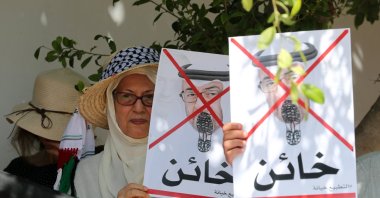 Tunisian protesters hold crossed out portraits of Abu Dhabi Crown Prince Sheikh Mohammed bin Zayed Al Nahyan with the word "traitor" written underneath it, during a protest against the leaders of the United Arab Emirates after forming diplomatic relations with Israel, in front of the UAE embassy in Tunis, Tunisia, Aug. 18, 2020. (EPA Photo)