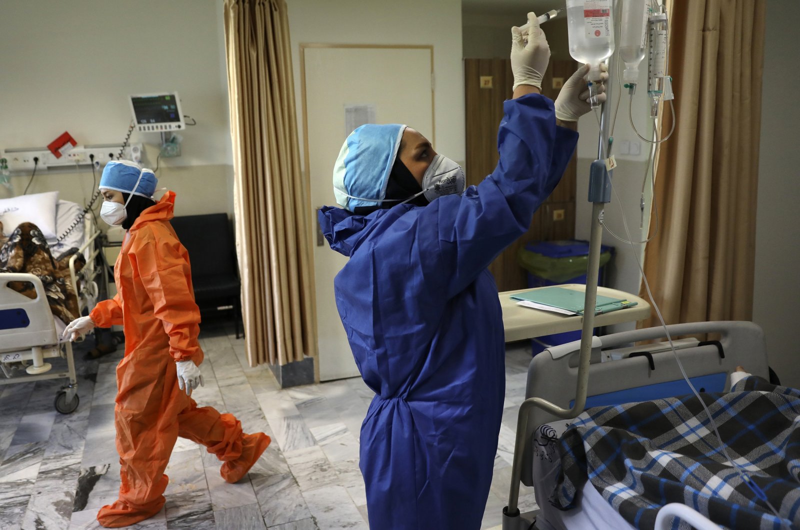 In this June 16, 2020, file photo, nurses tend to COVID-19 patients at the Shohadaye Tajrish Hospital in Tehran, Iran. (AP Photo)