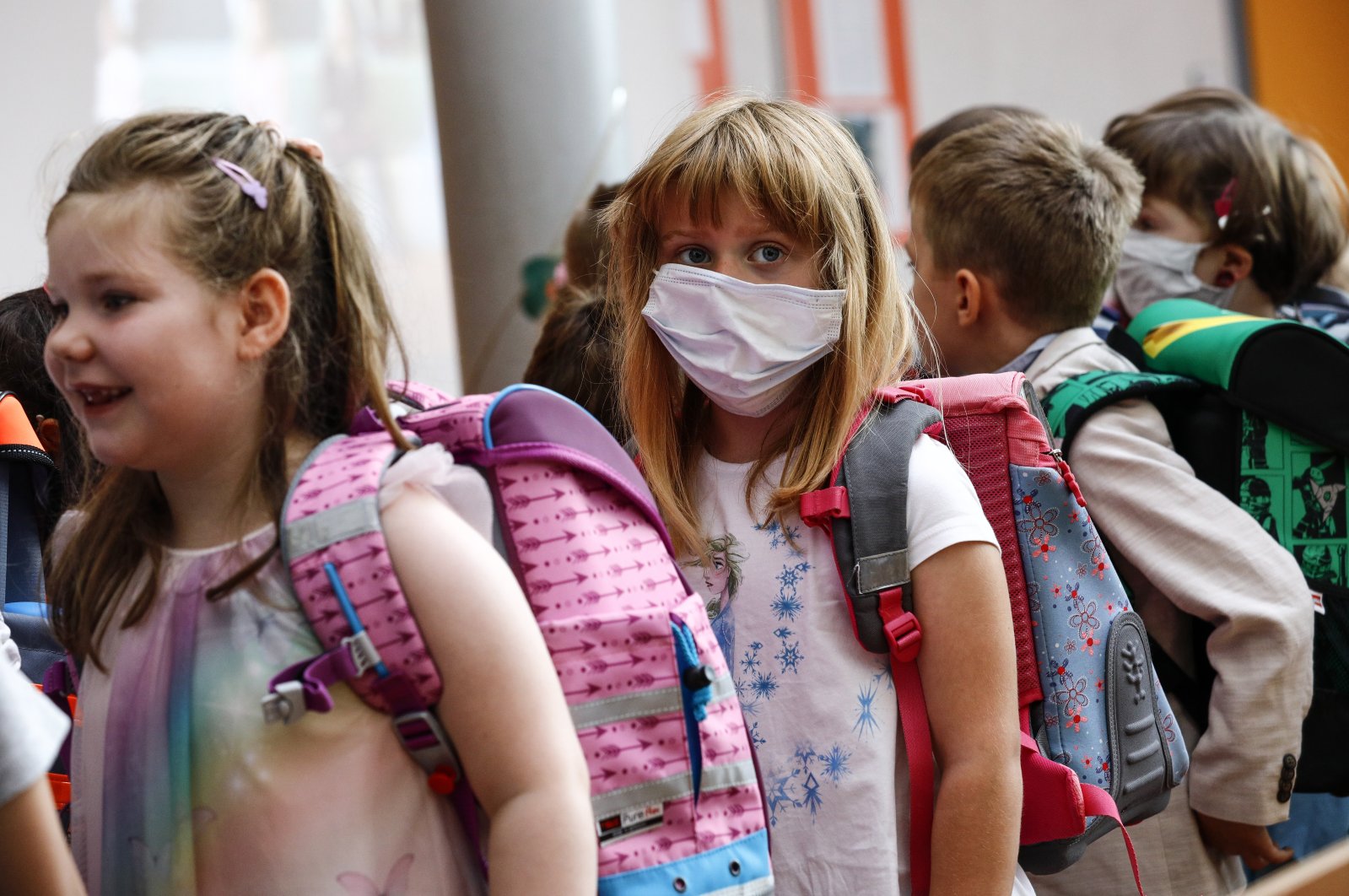 New pupil Angelina Bojahr (C) wears a sanitary mask during an enrolment ceremony in the Lankow elementary school in Schwerin, Germany, August 1, 2020. (EPA Photo)