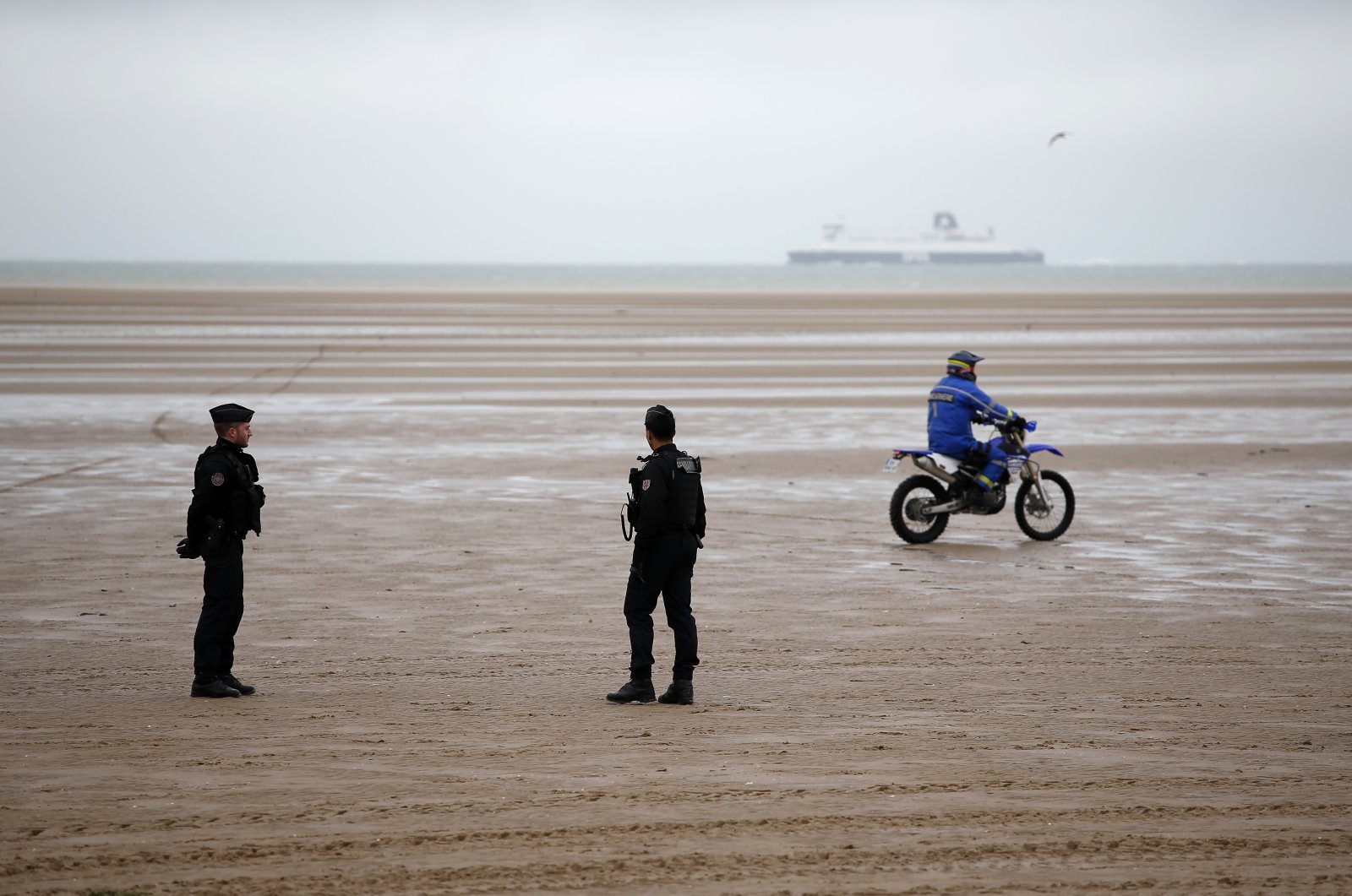 Police officers patrol on the beach of Oye-Plage, northern France, near Calais on Jan. 31, 2020. (AP Photo/Michel Spingler, File)