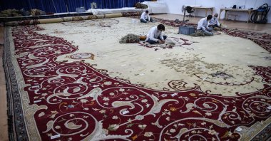 Restoration experts work on the carpet, Istanbul, Turkey, Aug. 19, 2020. (AA Photo)