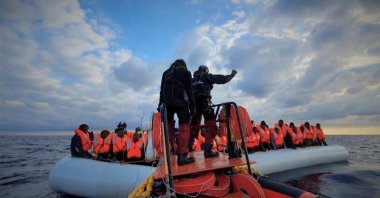 Migrants wearing life jackets on a rubber dinghy are pictured during a rescue operation, off the coast of Libya. (Reuters Photo)