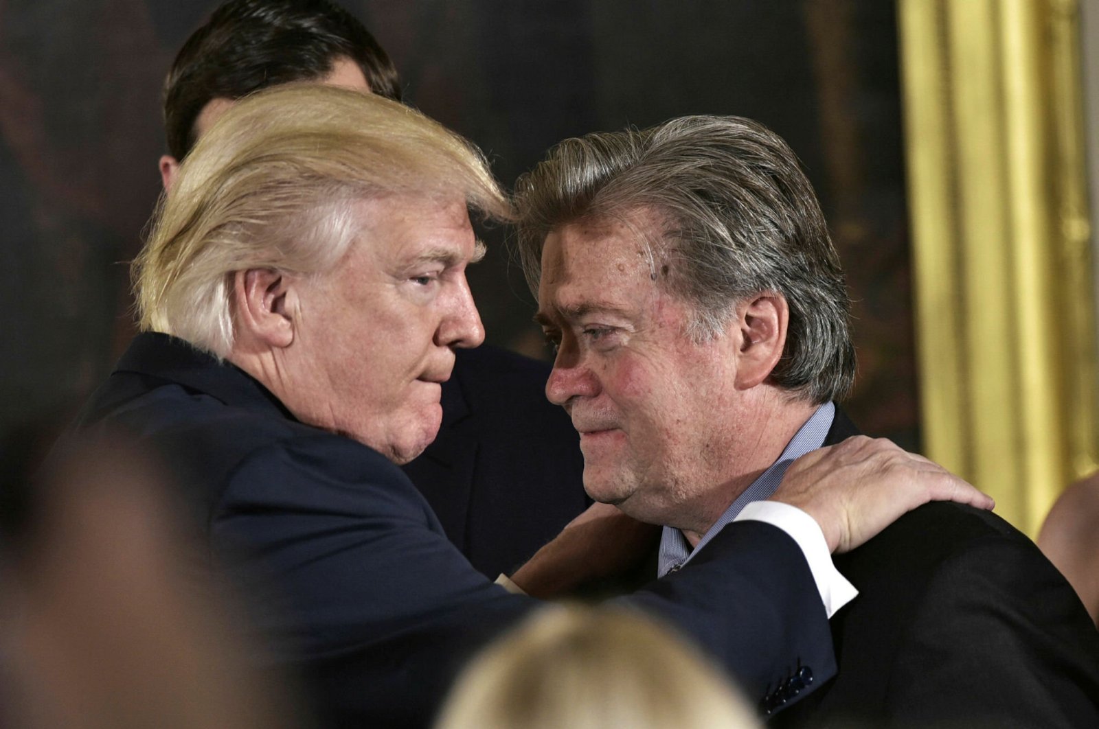 U.S. President Donald Trump congratulates his former advisor Stephen Bannon during the swearing-in of senior staff in the East Room of the White House, Washington, D.C., Jan. 22, 2017. (AFP Photo)