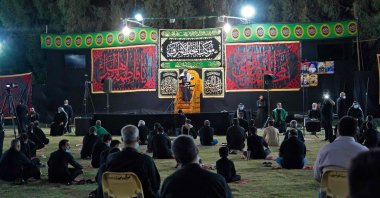 Iraqi Shiite Muslims respect social distancing in light of the coronavirus as they gather to commemorate the start of the month of Muharram ahead of Ashura, in the central city of Najaf, on August 20, 2020. (AFP Photo)