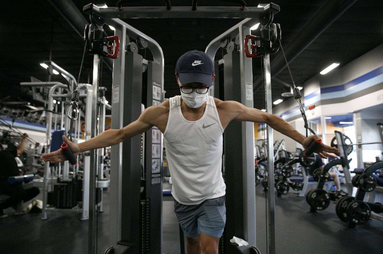 Benji Xiang, 32, wears a mask while working out at a gym in Los Angeles, California, U.S., June 26, 2020. (AP Photo)