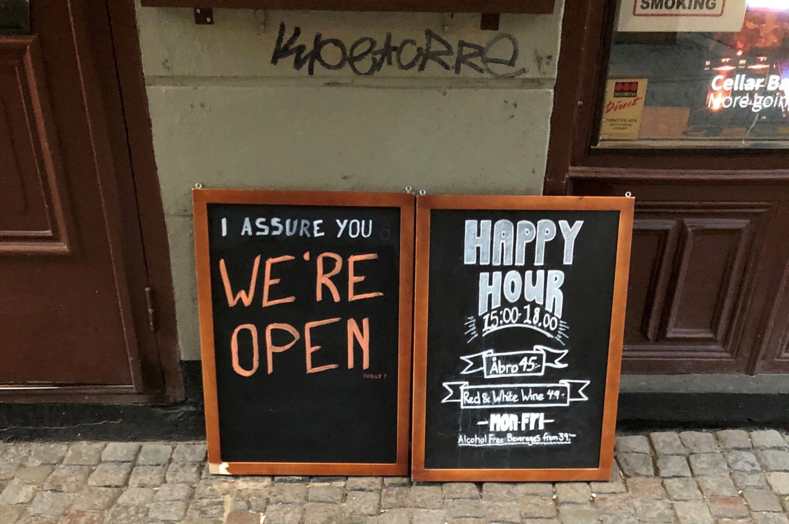 A sign assures people that the bar is open during the coronavirus outbreak, outside a pub in Stockholm, Sweden on March 26, 2020. (Reuters Photo)