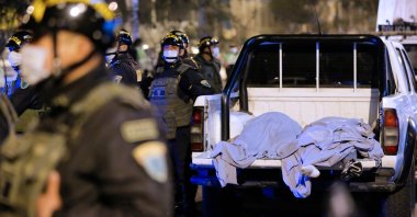 The bodies of some of the victims that suffocated in a crush during a raid on a nightclub in Lima, Peru, are seen on the back of a pickup truck outside the place where a party was being held despite a ban on such gatherings imposed to fight the coronavirus pandemic, Aug. 23, 2020. (AFP Photo)