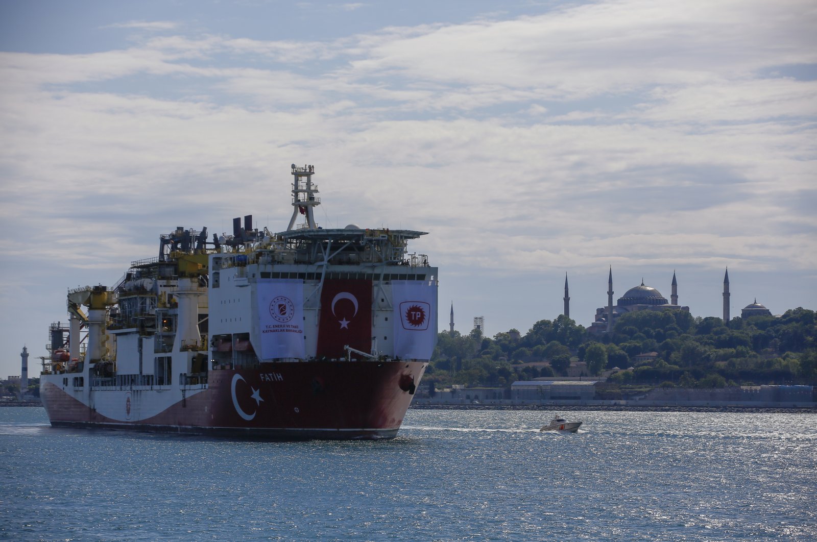 Turkey's drillship, Fatih, crosses the Bosporus as it heads toward the Black Sea with the Hagia Sophia Grand Mosque in the background, Istanbul, May. 29, 2020. (AP Photo)