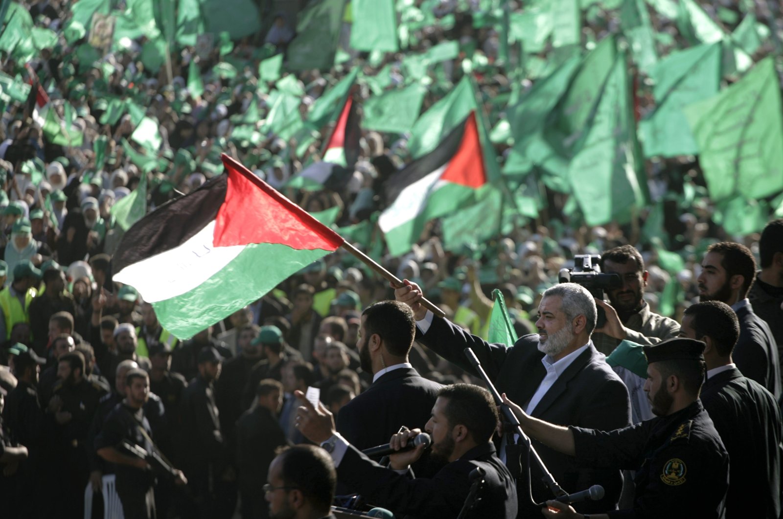 Chief of Hamas political bureau Ismail Haniyeh waves a Palestinian flag during a celebration of the 20th anniversary of the foundation of Hamas in this undated photo. (AP Photo)