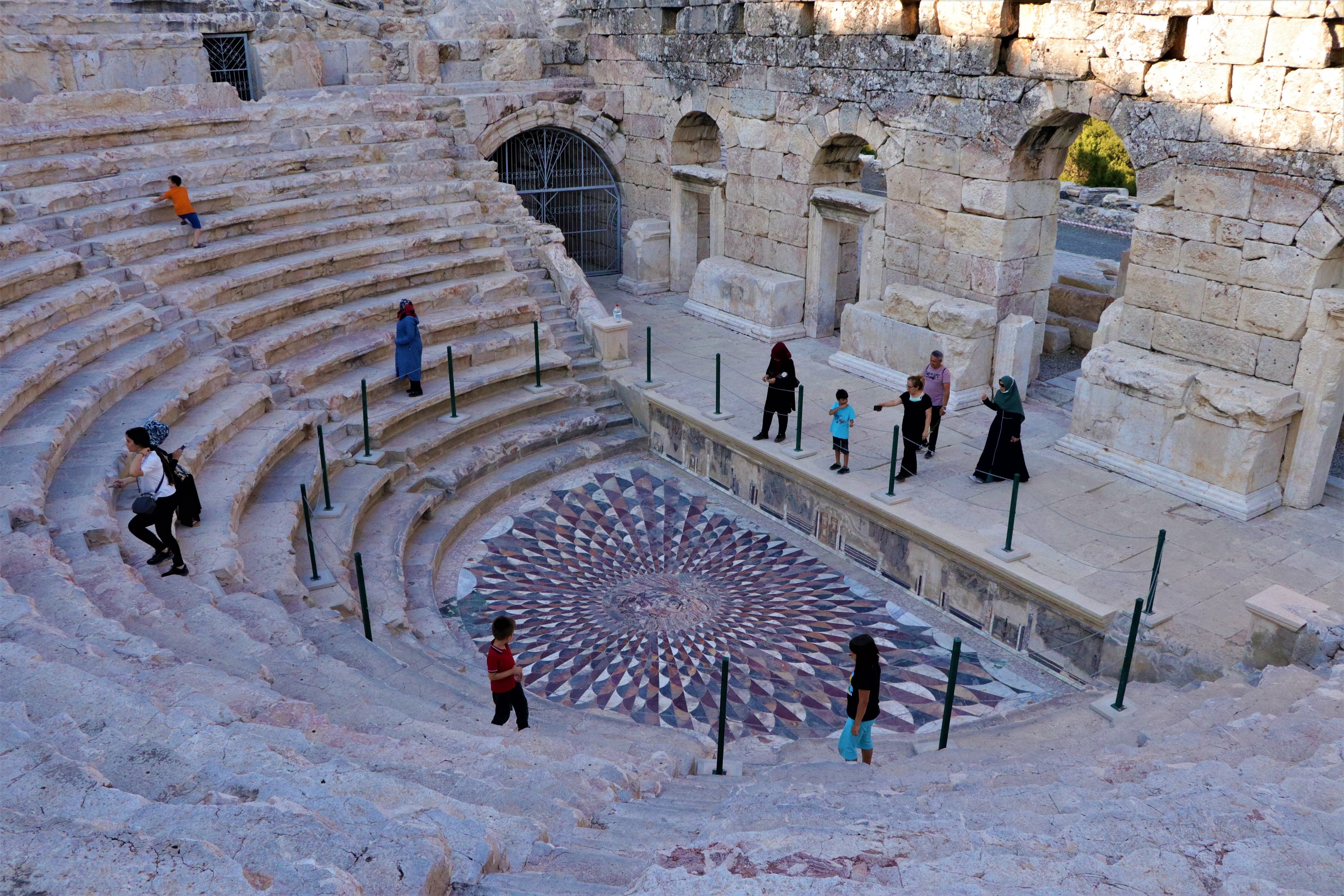 Some visitors are seen  examining Medusa mosaic at the Odeon of the ancient city of Kibyra, Burdur, southern Turkey, Aug. 22, 2020, (AA PHOTO)