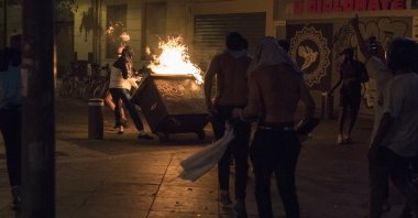 Fans hurl a burning container at police during violent riots reacting to Bayern Munich's victory in a Champions League final soccer match with Paris Saint-Germain, in Marseille, southern France, Aug. 23, 2020. (AP Photo)