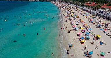 People are seen at Ilıca Beach in Çeşme, a resort town west of Izmir, in Turkey's Aegean region, July 19, 2020. (AA Photo)