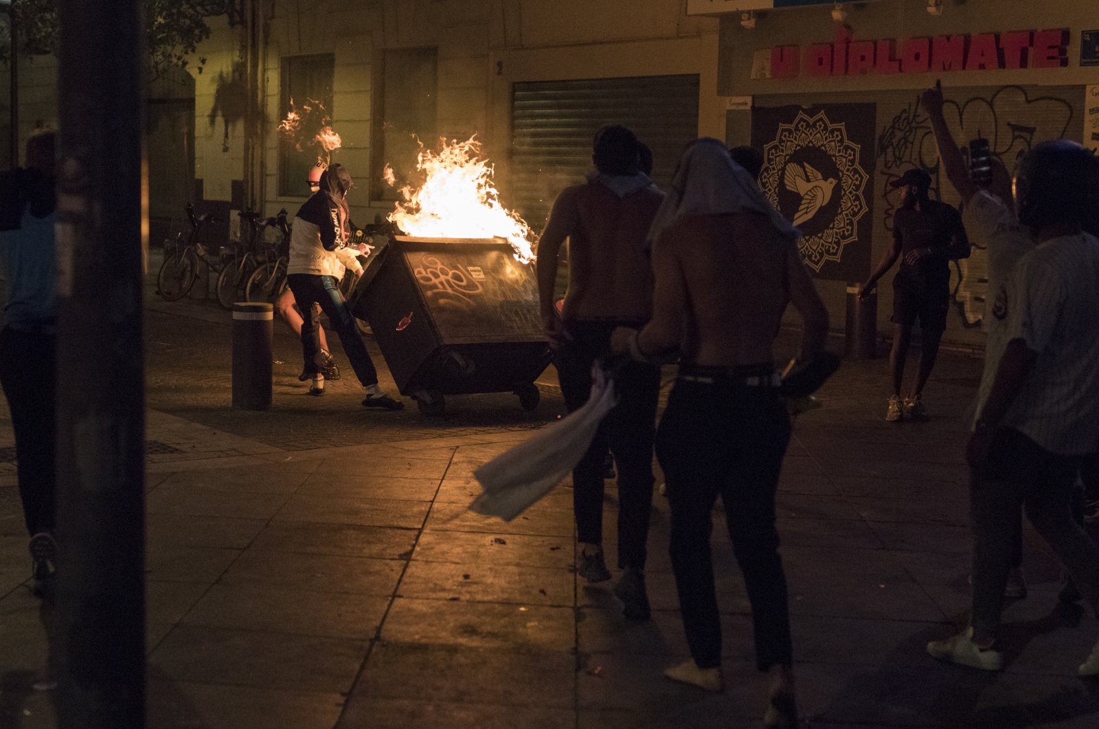 Fans hurl a burning container at police during violent riots reacting to Bayern Munich's victory in a Champions League final soccer match with Paris Saint-Germain, in Marseille, southern France, Aug. 23, 2020. (AP Photo)