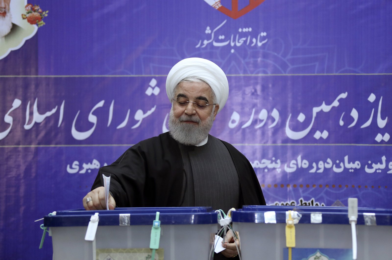 In this photo released by the official website of the office of the Iranian presidency, President Hassan Rouhani casts his ballot in the parliamentary elections at the interior ministry in Tehran, Iran, Feb. 21, 2020. (Iranian Presidency Office Photo via AP)