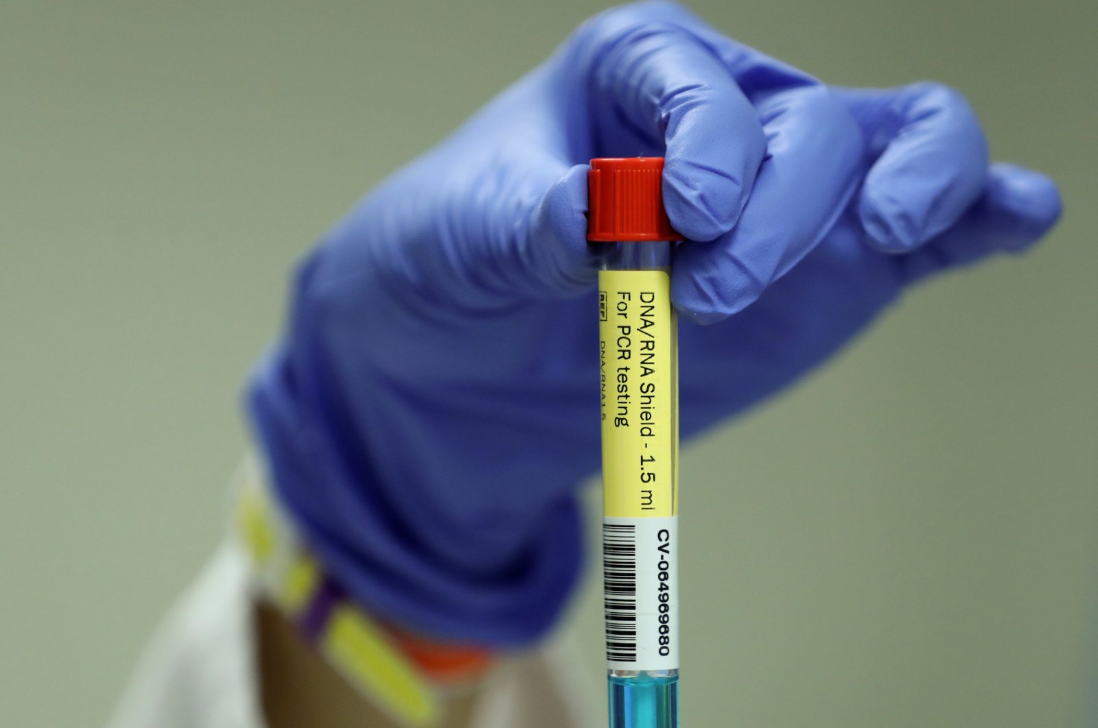A laboratory worker shows a PCR test for the coronavirus disease at the University of Liege, Belgium. Aug. 12, 2020. (Reuters Photo)