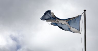 A torn Scottish Saltire flag hangs over the Royal Mile in Edinburgh, Scotland, Aug. 21, 2020. (AP Photo)