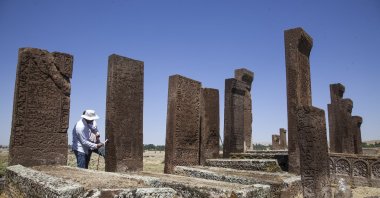 Archaeologists work on a tombstone at the Ahlat Seljuk Meydan Cemetery, in the Ahlat district of Bitlis province, eastern Turkey, Aug. 22, 2020. (AA PHOTO)