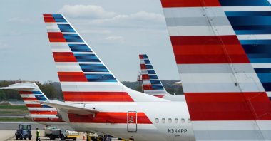 A member of a ground crew walks past American Airlines planes parked at the gate during the coronavirus disease (COVID-19) outbreak at Ronald Reagan National Airport in Washington, U.S., April 5, 2020. (Reuters Photo)