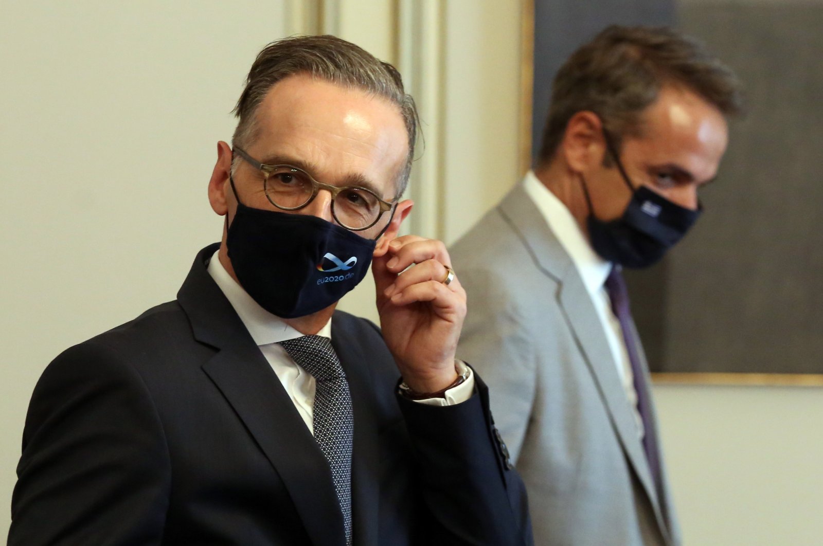 Foreign Minister of Germany Heiko Maas (L) takes off his mask during his meeting with Greek Prime Minister Kyriakos Mitsotakis (R), in Athens, Greece, Aug. 25, 2020. (EPA Photo)