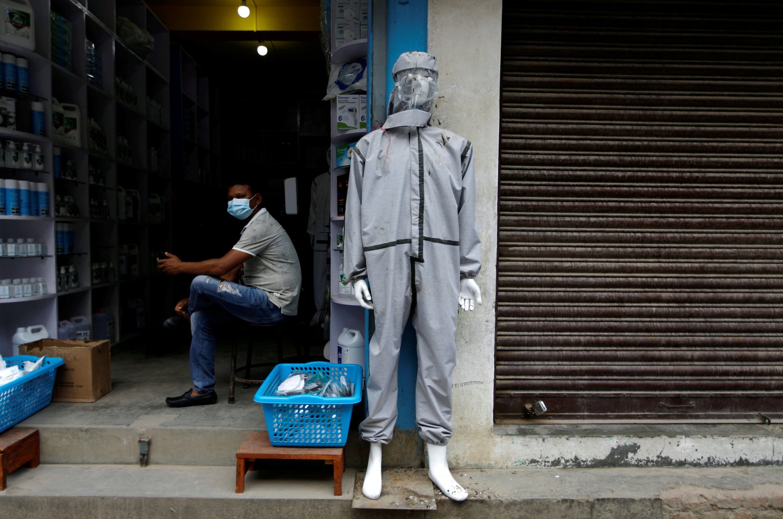 A mannequin, wearing personal protective equipment (PPE), is displayed outside a drug store, Kathmandu, Nepal, Aug. 20, 2020. (REUTERS Photo)