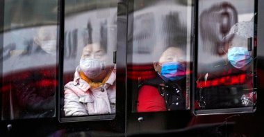People wear protective face masks on a bus following an outbreak of COVID-19 in downtown Shanghai, China, March 16, 2020. (REUTERS Photo)