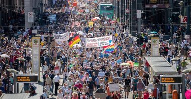 Thousands march along the "Friedrichstrasse" during a demonstration against coronavirus curbs in Berlin, Germany, Aug. 2, 2020. (AP Photo)