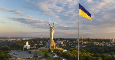Ukraine's biggest flag flies 90 meters above Kyiv after it was installed on the eve of the State Flag Day, with the Motherland Monument at the center, Ukraine, Aug. 22, 2020. (AP Photo)