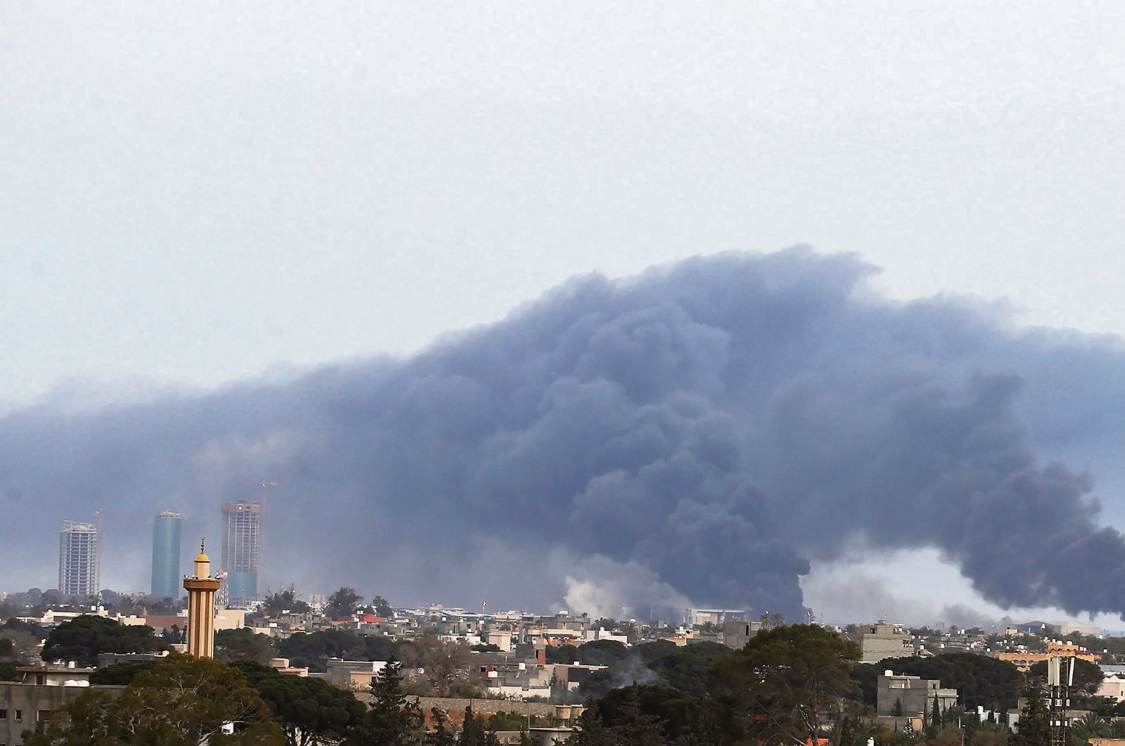 Plumes of smoke rise above buildings in the Libyan capital Tripoli, during reported shelling by putschist Gen. Khalifa Haftar's forces, May 9, 2020 (AFP File Photo)