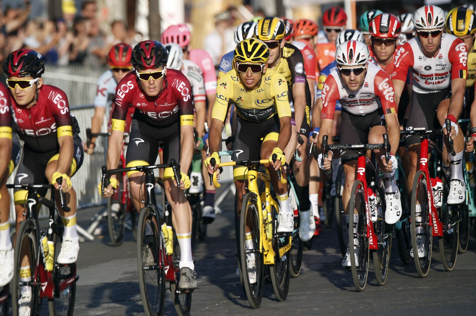 Colombia's Egan Bernal, wearing the overall leader's yellow jersey (C), races on the Champs Elysees during the Tour de France in Paris, France, July 28, 2019. (AP Photo)