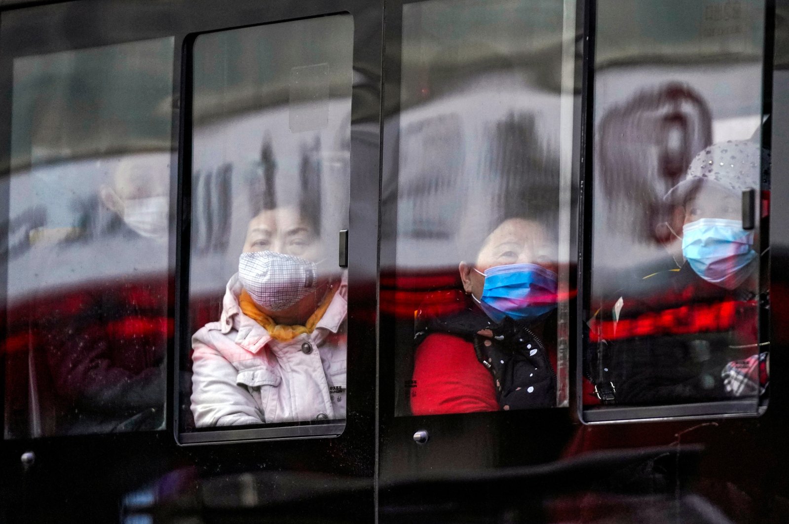 People wear protective face masks on a bus following an outbreak of COVID-19 in downtown Shanghai, China, March 16, 2020. (REUTERS Photo)
