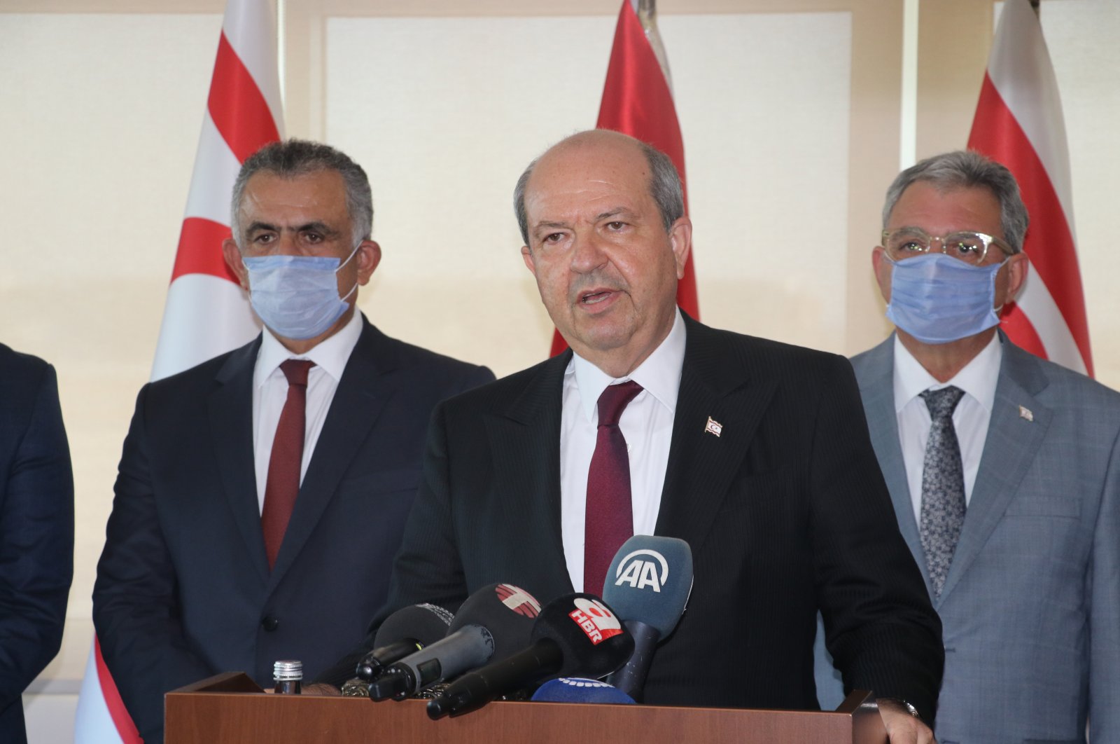 TRNC PM Ersin Tatar (C) gives a press conference in Nicosia's Ercan International Airport after returning to the island of Cyprus after official talks in Turkey, Aug. 5, 2020 (AA Photo)