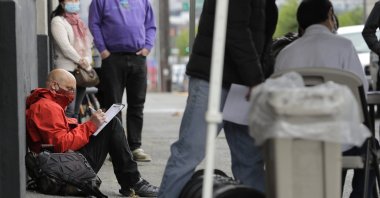 A man fills out a job application during a walk- and drive-up job fair in Seattle, Washington, U.S., May 16, 2020. (AP Photo)