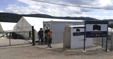 Migrants at the gate of the Lipa refugee camp outside Bihac, northwestern Bosnia-Herzegovina, Aug. 27, 2020. (AP Photo)