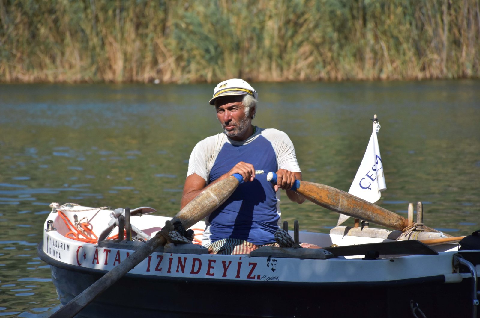 Hüseyin Ürkmez aboard his rowboat in the Dalyan district of Muğla province, southwestern Turkey, Aug. 27, 2020. (AA Photo)
