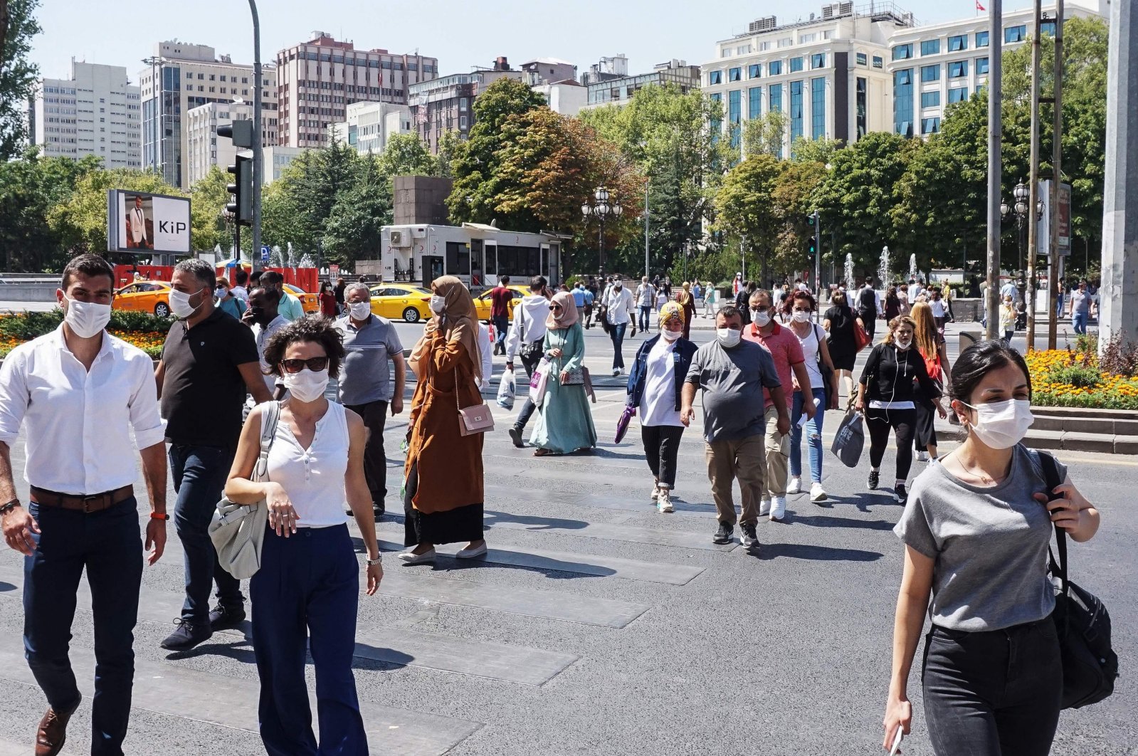 Pedestrians wear face masks as they walk in a street in the capital Ankara, Turkey, Aug. 26, 2020. (AFP Photo) 