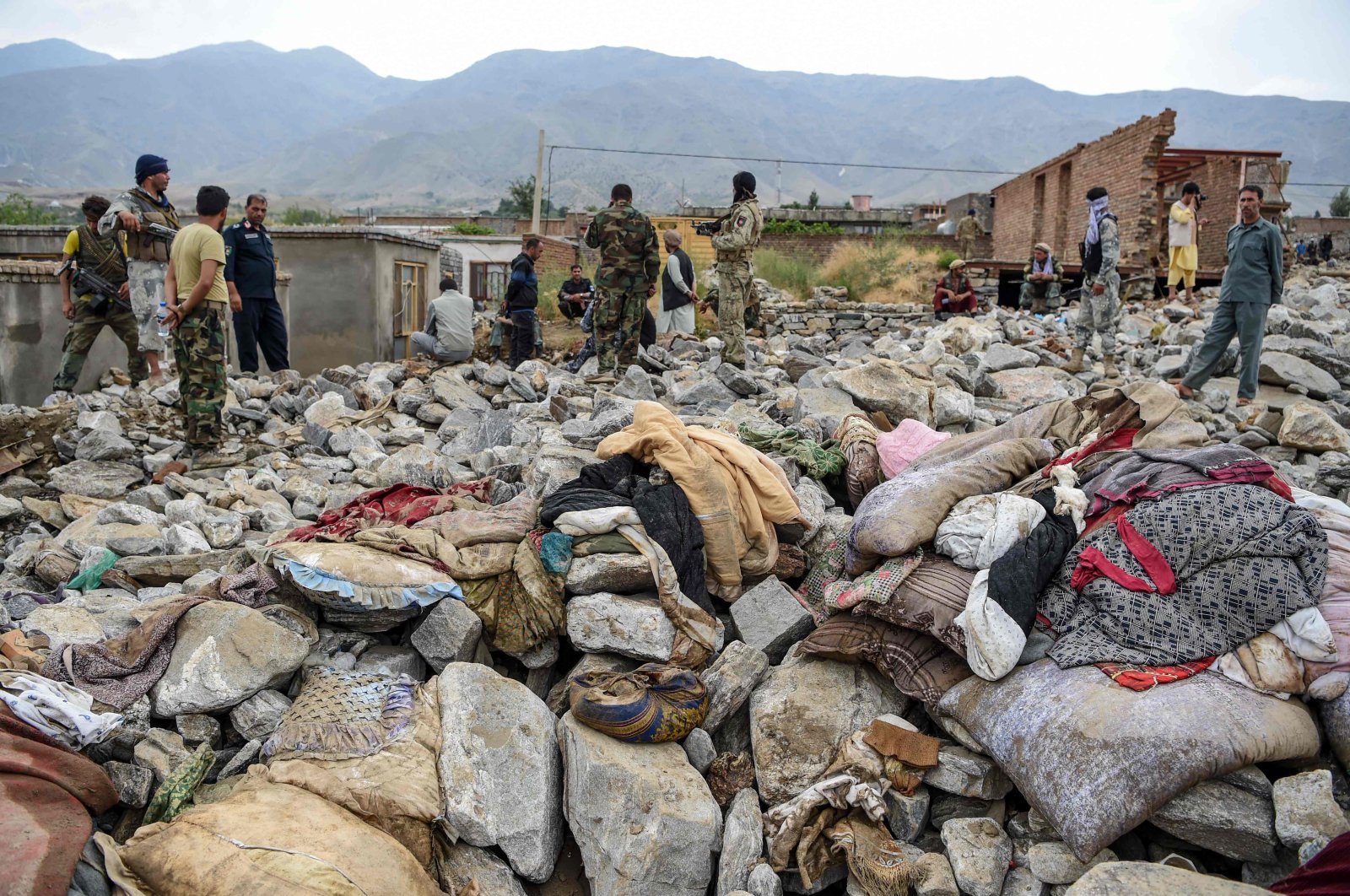 Villagers and security personnel gather after a flash flood affected the area at Sayrah-e-Hopiyan in Charikar, Parwan province, Afghanistan, Aug. 26, 2020. (AFP Photo)