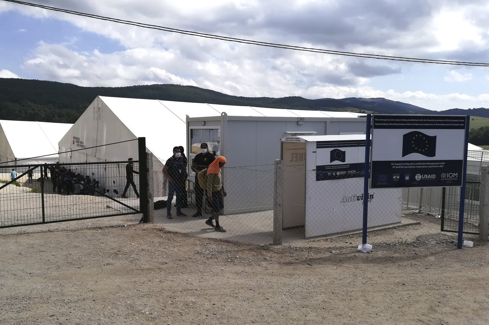 Migrants at the gate of the Lipa refugee camp outside Bihac, northwestern Bosnia-Herzegovina, Aug. 27, 2020. (AP Photo)