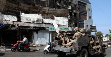 Lebanese soldiers patrol near burnt shops in the aftermath of clashes, Khaldeh, Lebanon, Aug. 28, 2020. (Reuters Photo)