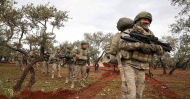 Turkish soldiers gather in the village of Qaminas, about 6 kilometers (3.7 miles) southeast of Idlib city in northwestern Syria, Feb. 10, 2020. (AFP Photo)